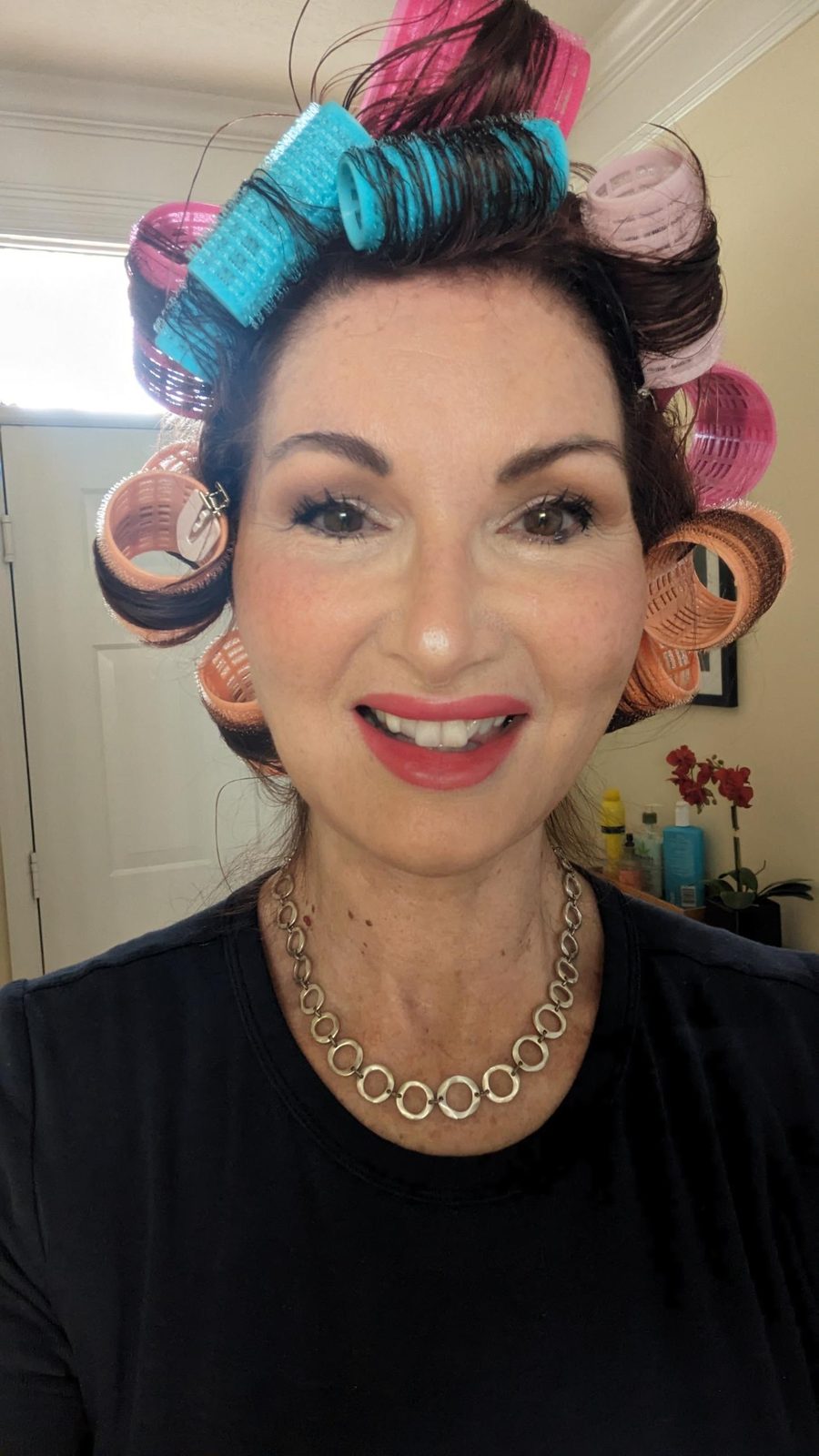 Tracy smiling with her hair in colorful rollers